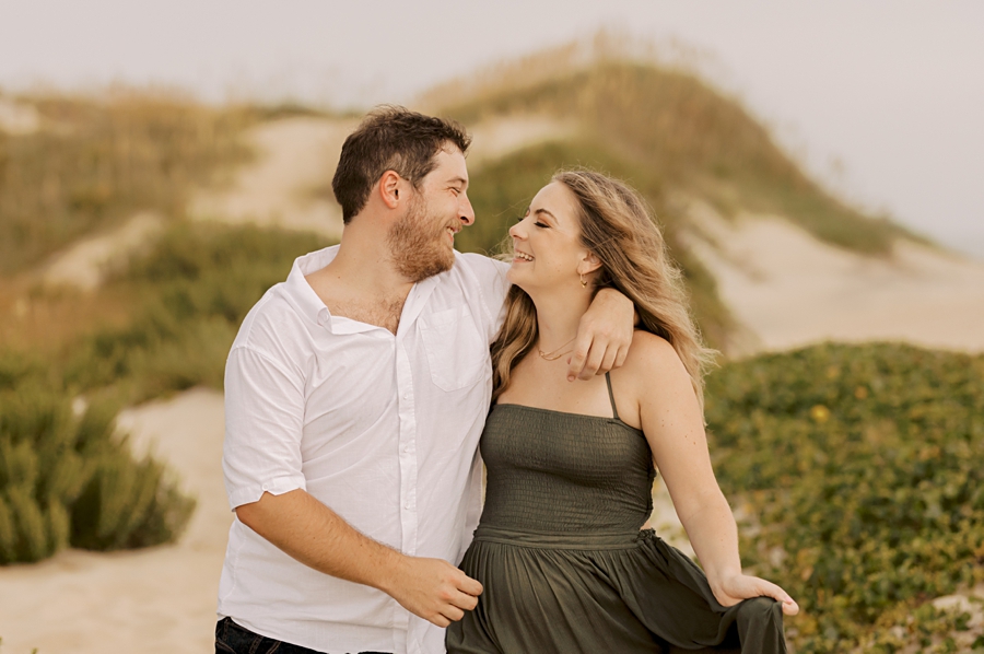 engaged couple on dunes in nags head, nc by sharon elizabeth co