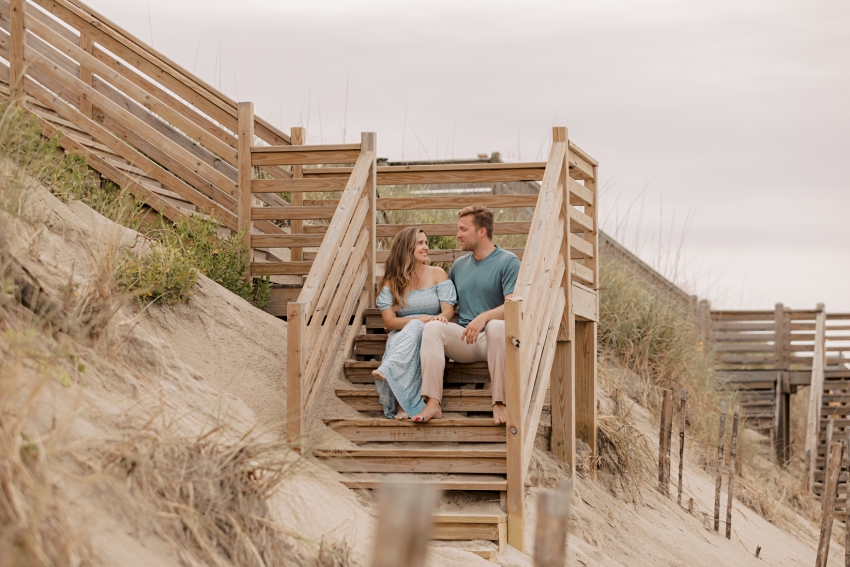couple on dune stairs outer banks photos by sharon elizabeth co