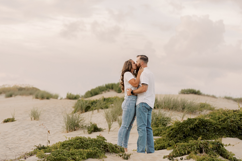 couple kissing on beach dunes, sharon elizabeth co