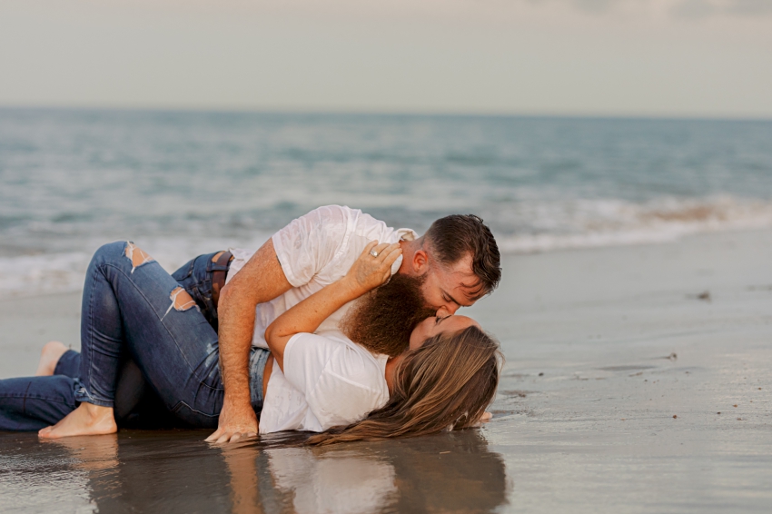 couple kissing in the sand and water, sharon elizabeth co