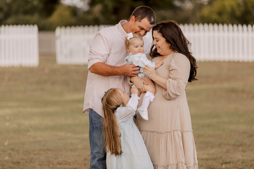 Family cuddled up with two small daughters | Family Session in Smithfield, Virginia by Sharon Elizabeth Co