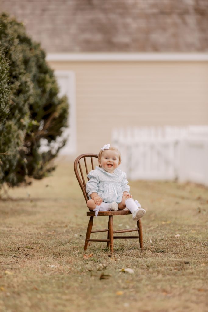 little girl sitting in wooden chair with vintage outfit | Family Session in Smithfield, Virginia by Sharon Elizabeth Co