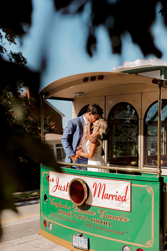 bride and groom kissing on trolley by sharon elizabeth co