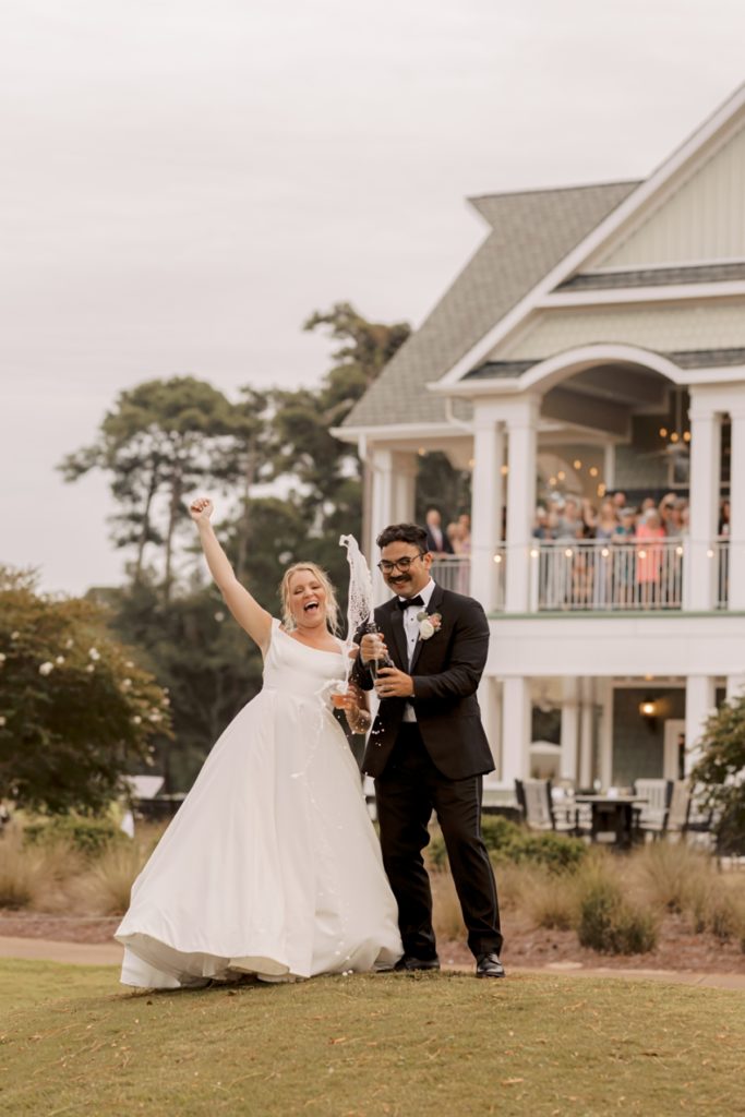 bride and groom popping champagne at duck woods country club by sharon elizabeth co