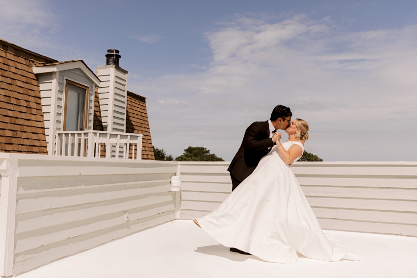 bride and groom portraits on cottage roof in kitty hawk, nc by sharon elizabeth co