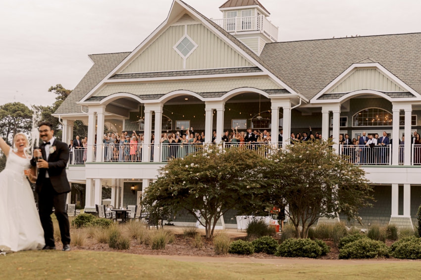 wedding guests cheering on balcony of duck woods country club by sharon elizabeth co
