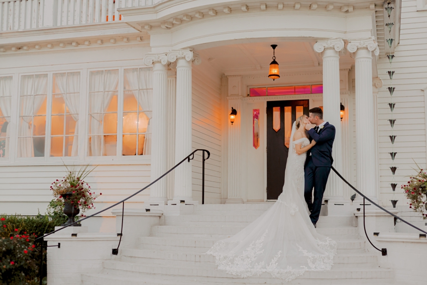 bride and groom on the steps of obici house in suffolk va by sharon elizabeth photography
