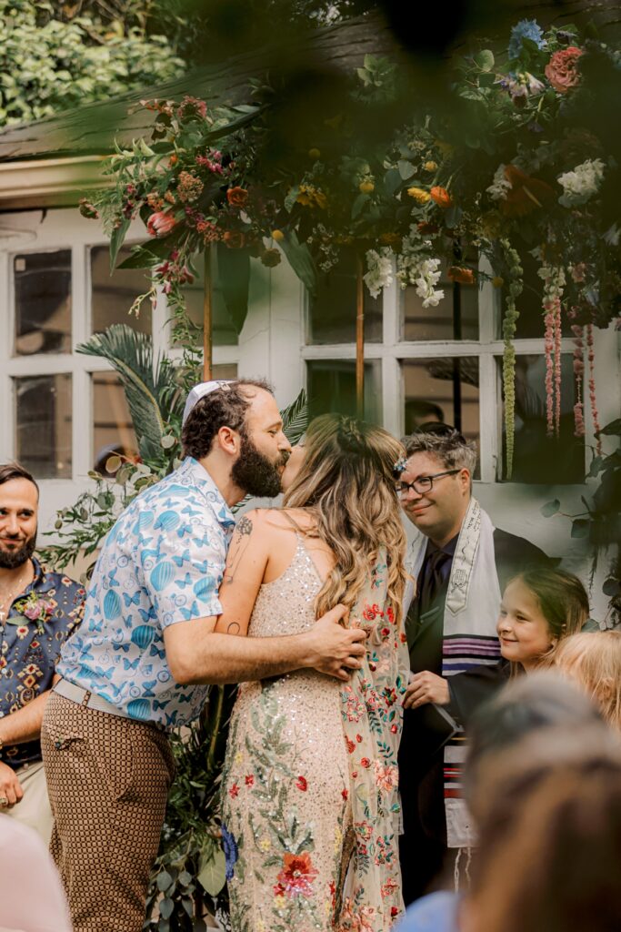 first kiss in backyard rainbow wedding