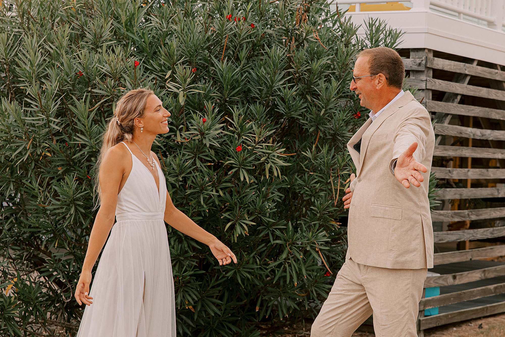 bride approaches dad outside cottage for first look 