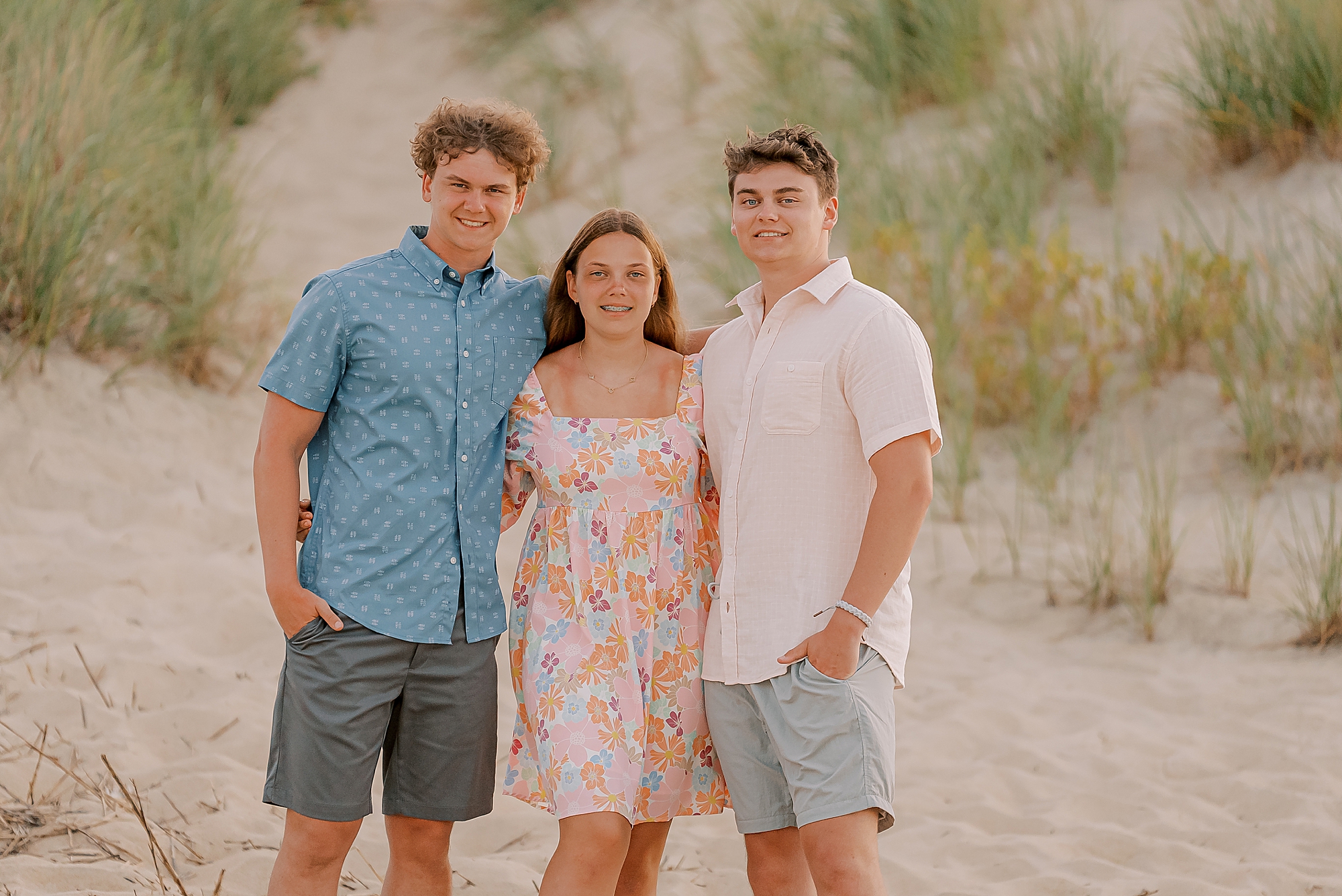 three siblings hug during outer banks family photos