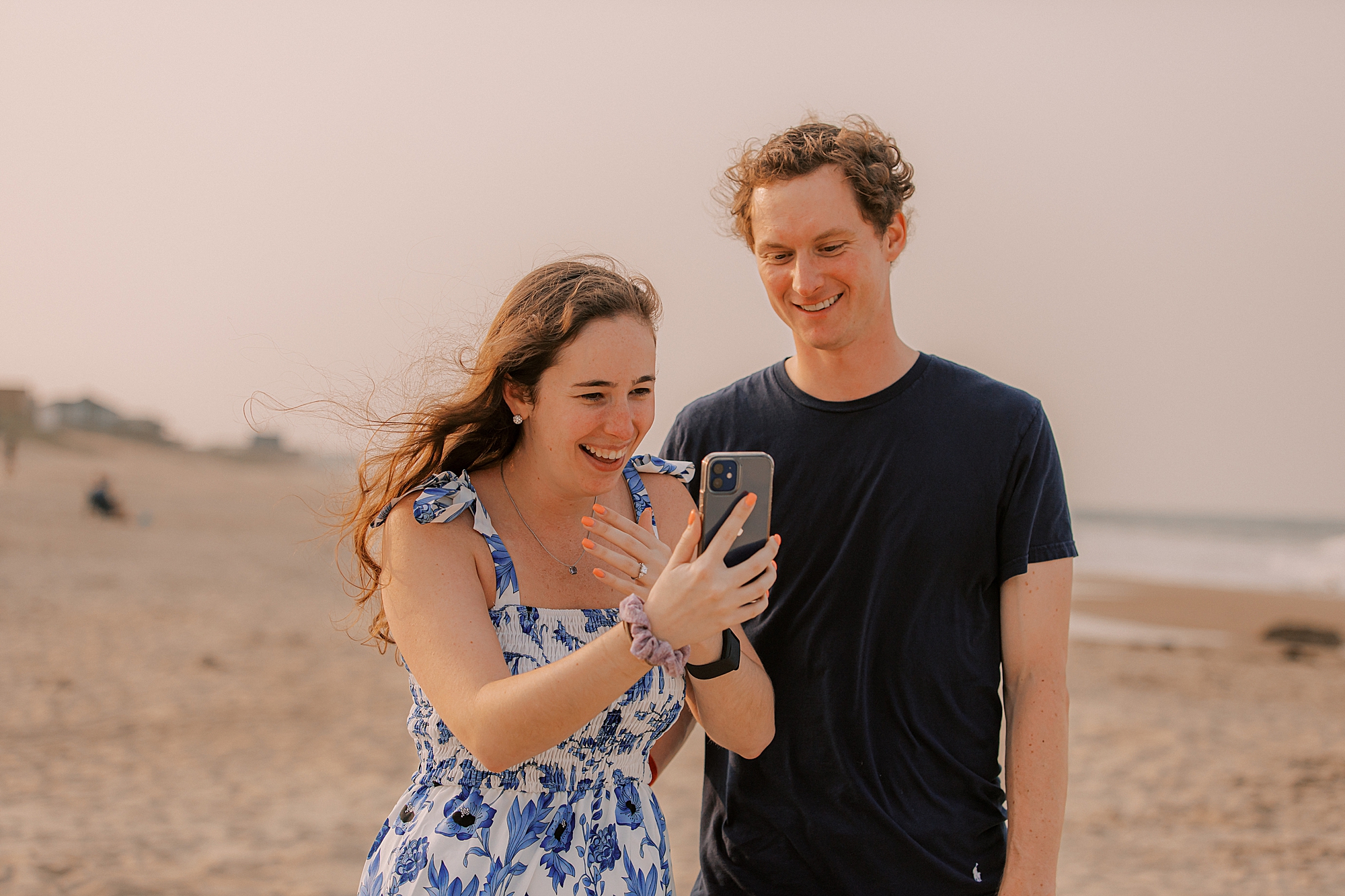 couple makes video call on beach after surprise proposal