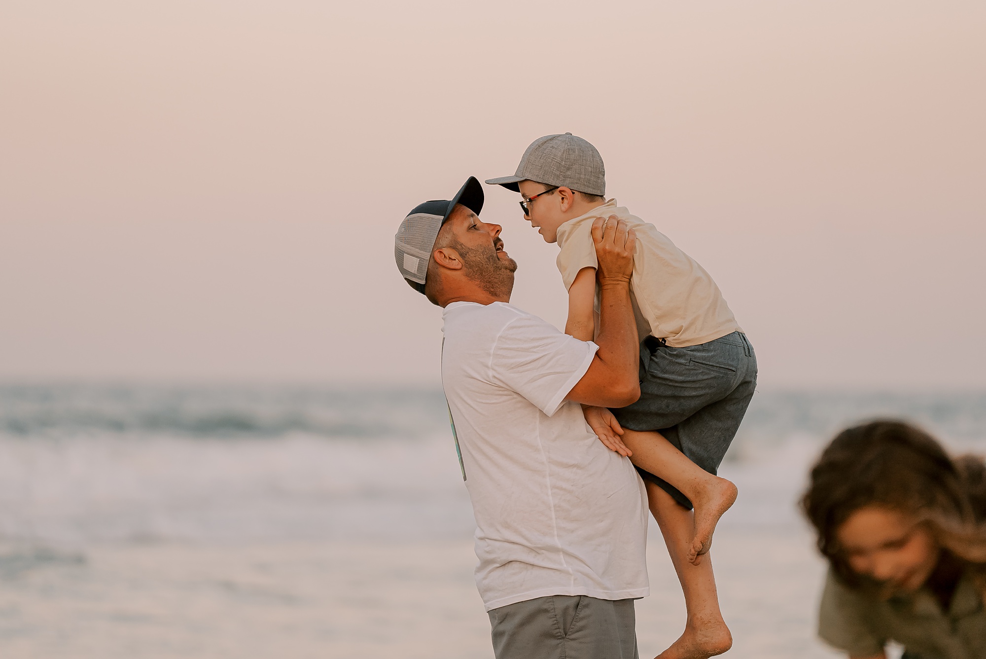 dad and son play during sunset family photos in the outer banks 